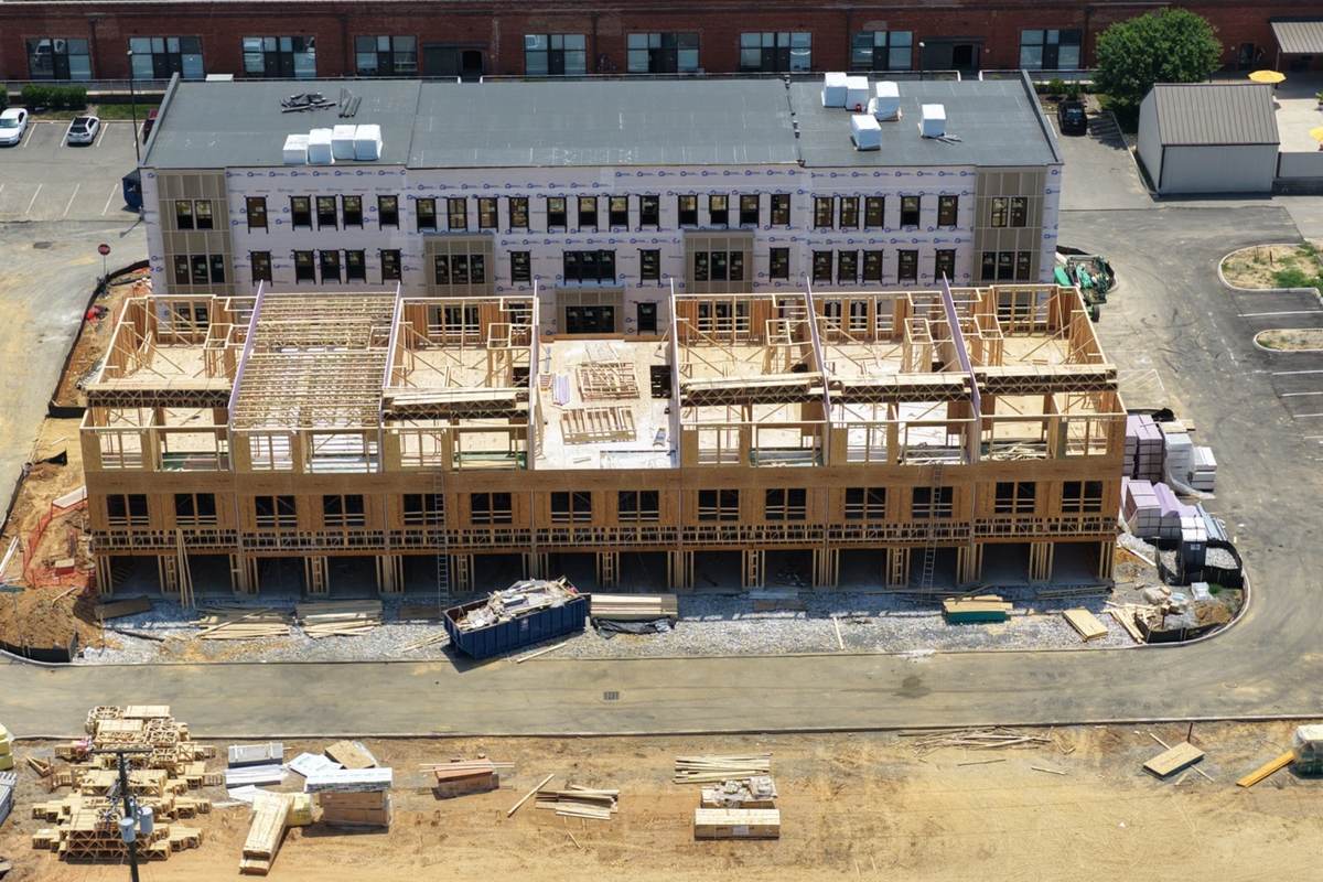 Front aerial view of apartment framing progress and exterior construction documentation
