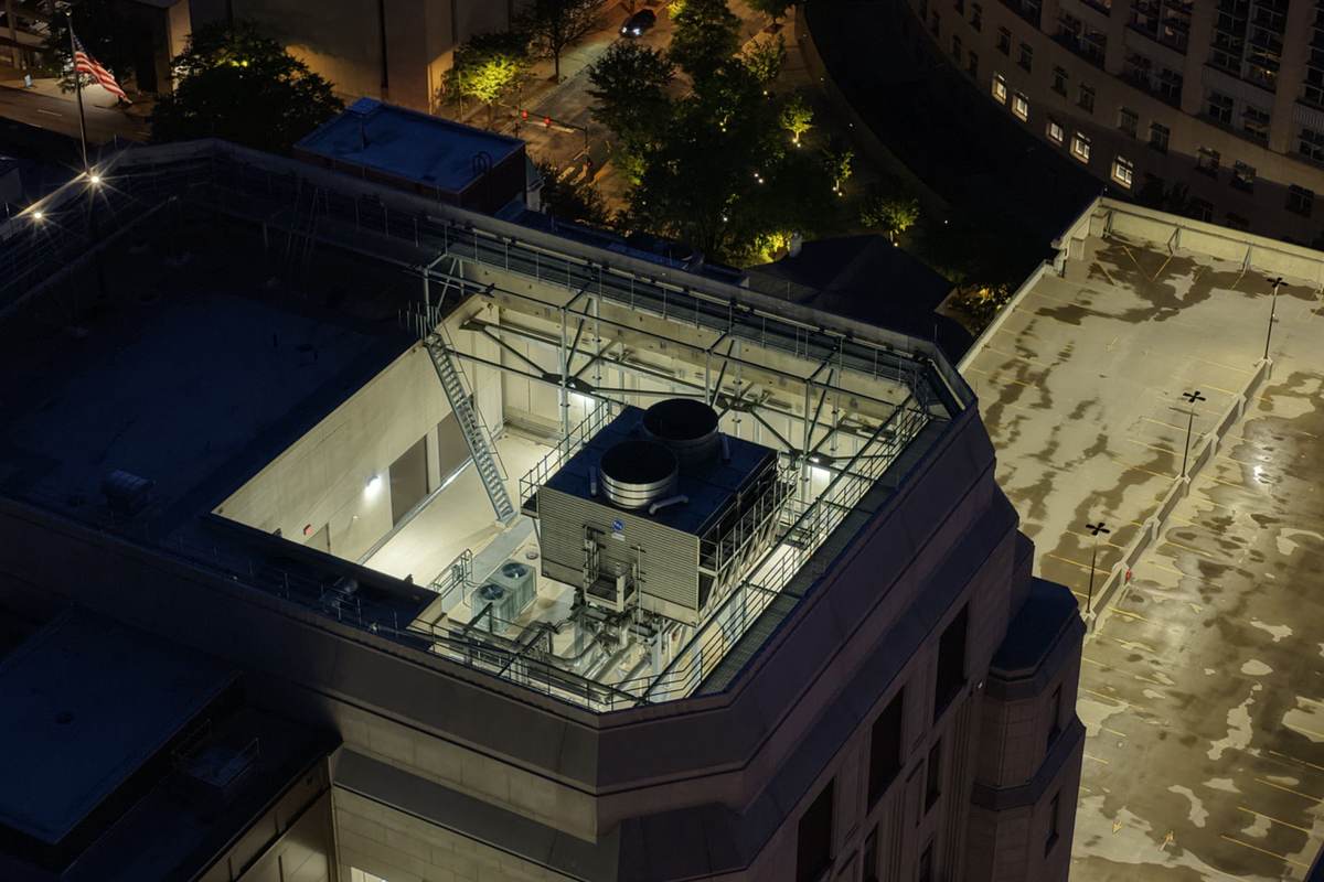 Night aerial rooftop documentation showing mechanical equipment, access platforms, and commercial roof conditions